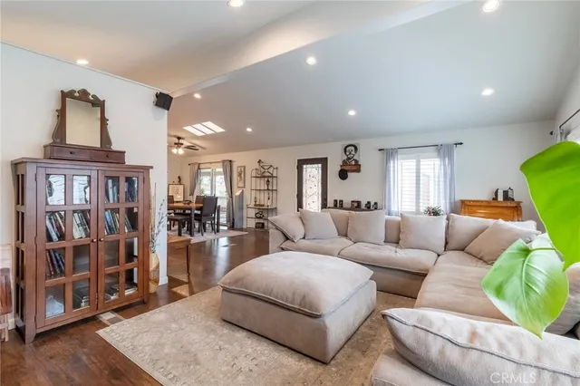 a living room with furniture and a book shelf