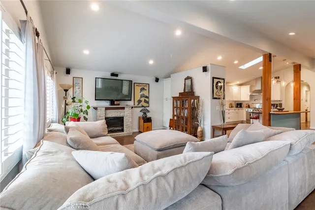 a living room with fireplace furniture and a flat screen tv