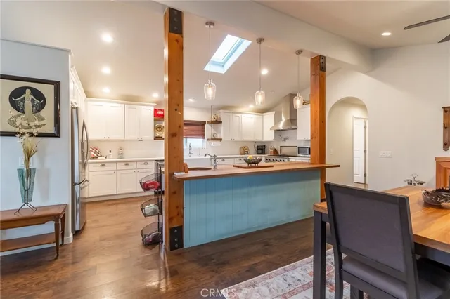 a kitchen with stainless steel appliances granite countertop a refrigerator and a stove top oven