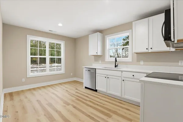 a view of a kitchen with microwave and windows