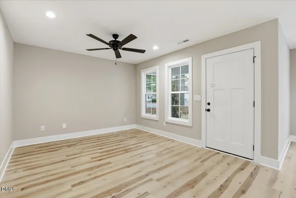 wooden floor in an empty room with a window