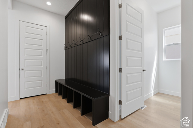 538 North Legend Circle, Unit 505 Mapleton, UT 84664 - Photo 30 of 48 Built-in black storage bench with cubbies, black wainscoting with coat hooks, light wood-finish flooring, white paneled doors, and recessed lighting