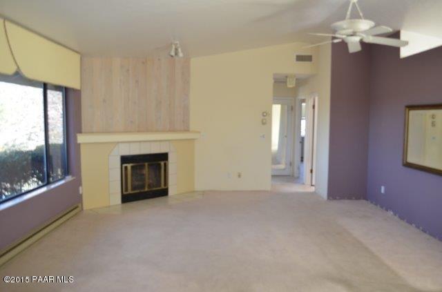 425 Buckskin Road Prescott, AZ 86301 - Photo 6 of 24 a view of empty room with a fireplace and fan