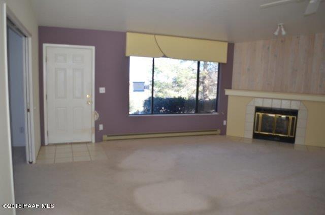 425 Buckskin Road Prescott, AZ 86301 - Photo 7 of 24 an empty room with windows and fireplace
