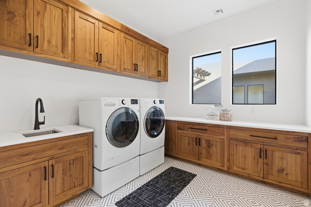 2197 Reserve Circle St. George, UT 84770 - Photo 39 of 57 Laundry area featuring cabinet space, separate washer and dryer, and light flooring