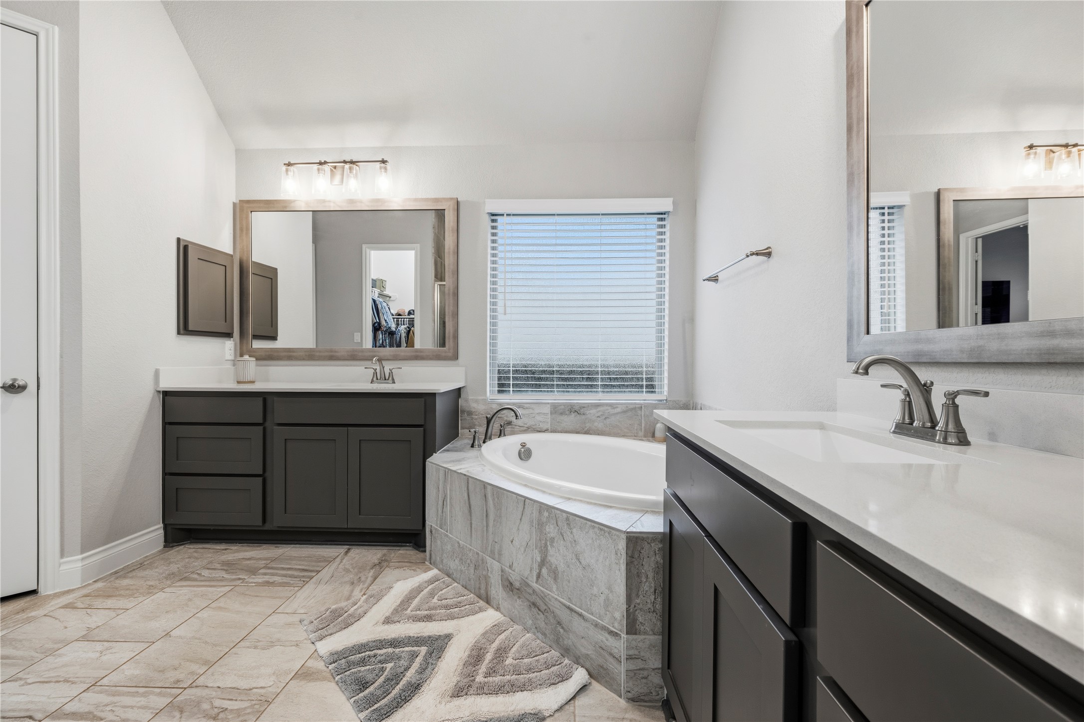 140 Catani Loop Georgetown, TX 78628 - Photo 31 of 36 Luxurious soaking tub and dual vanities define this elegant bathroom retreat.