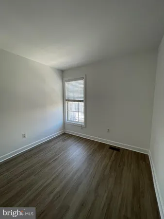 a bathroom with a sink a toilet and shower curtain
