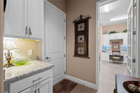 a bathroom with a granite countertop sink a mirror and vanity