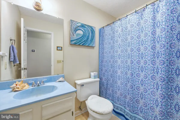 a bedroom with a bed a book shelf and a shelf