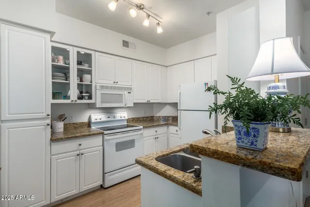 a kitchen with a white cabinets and white appliances