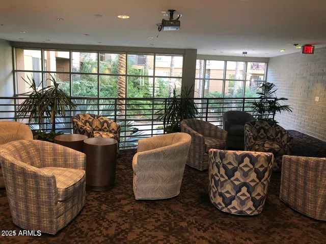 a living room with furniture and a floor to ceiling window