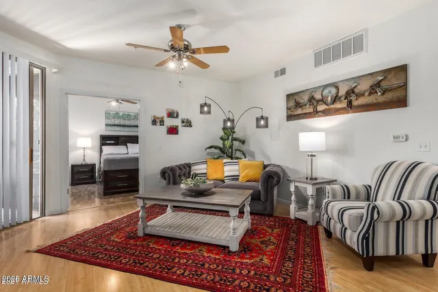 a living room with furniture and a wooden floor