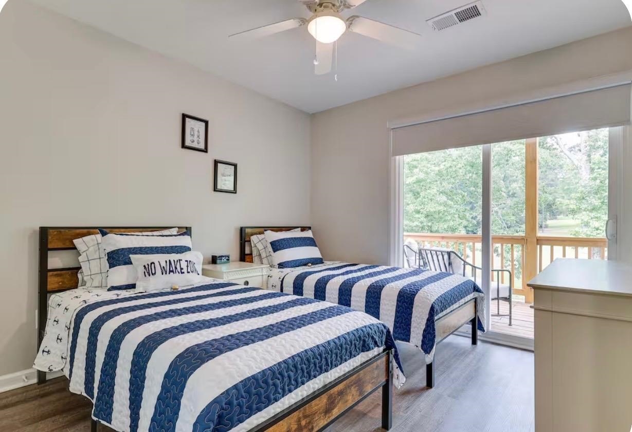 110 Bogey Loop Counce, TN 38326 - Photo 13 of 18 Room with wood-finish flooring, a ceiling fan, and a sliding glass door leading to an outdoor deck