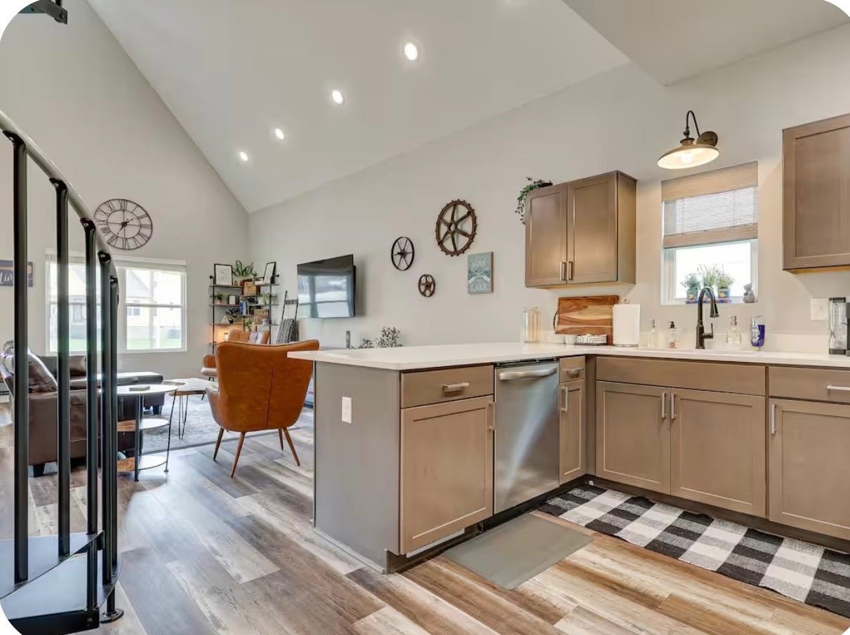 110 Bogey Loop Counce, TN 38326 - Photo 5 of 18 Kitchen featuring a peninsula island, stainless steel dishwasher, L-shaped cabinetry, and light-toned countertops
