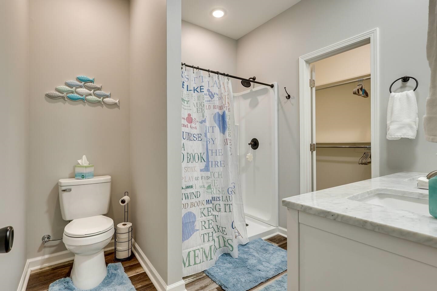 110 Bogey Loop Counce, TN 38326 - Photo 9 of 18 Full bath with vanity, a shower stall, and dark wood-style floors
