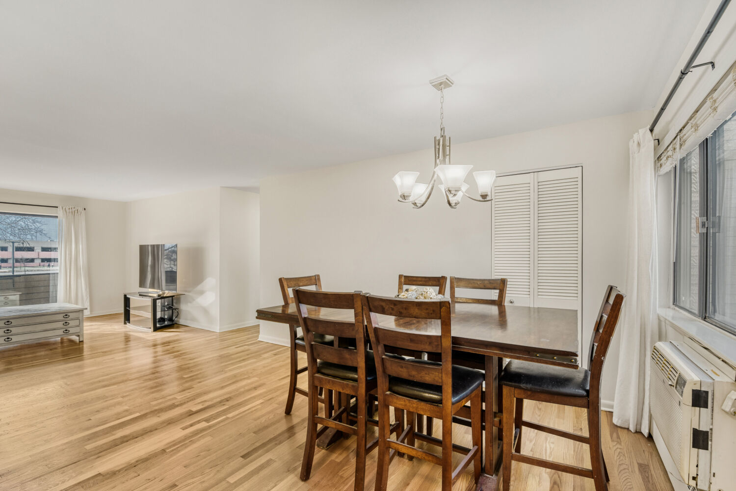 1710 Dempster Street, Unit B Park Ridge, IL 60068 - Photo 11 of 27 a view of a dining room with furniture wooden floor and chandelier