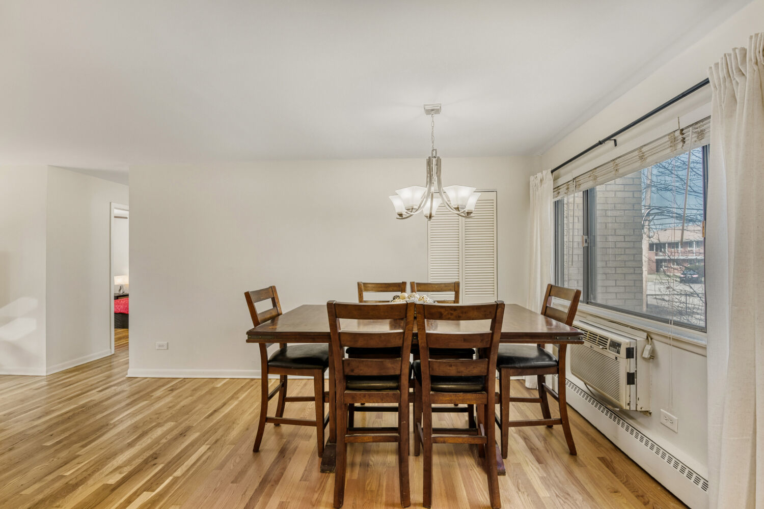 1710 Dempster Street, Unit B Park Ridge, IL 60068 - Photo 12 of 27 a view of a dining room with furniture window and wooden floor