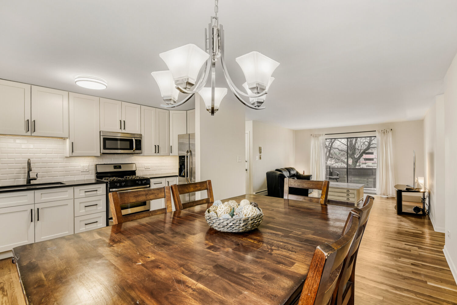 1710 Dempster Street, Unit B Park Ridge, IL 60068 - Photo 14 of 27 a kitchen with stainless steel appliances granite countertop a stove top oven a sink dishwasher and white cabinets with wooden floor