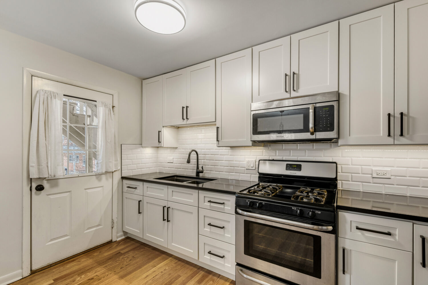 1710 Dempster Street, Unit B Park Ridge, IL 60068 - Photo 15 of 27 a kitchen with stainless steel appliances white cabinets and stove top oven