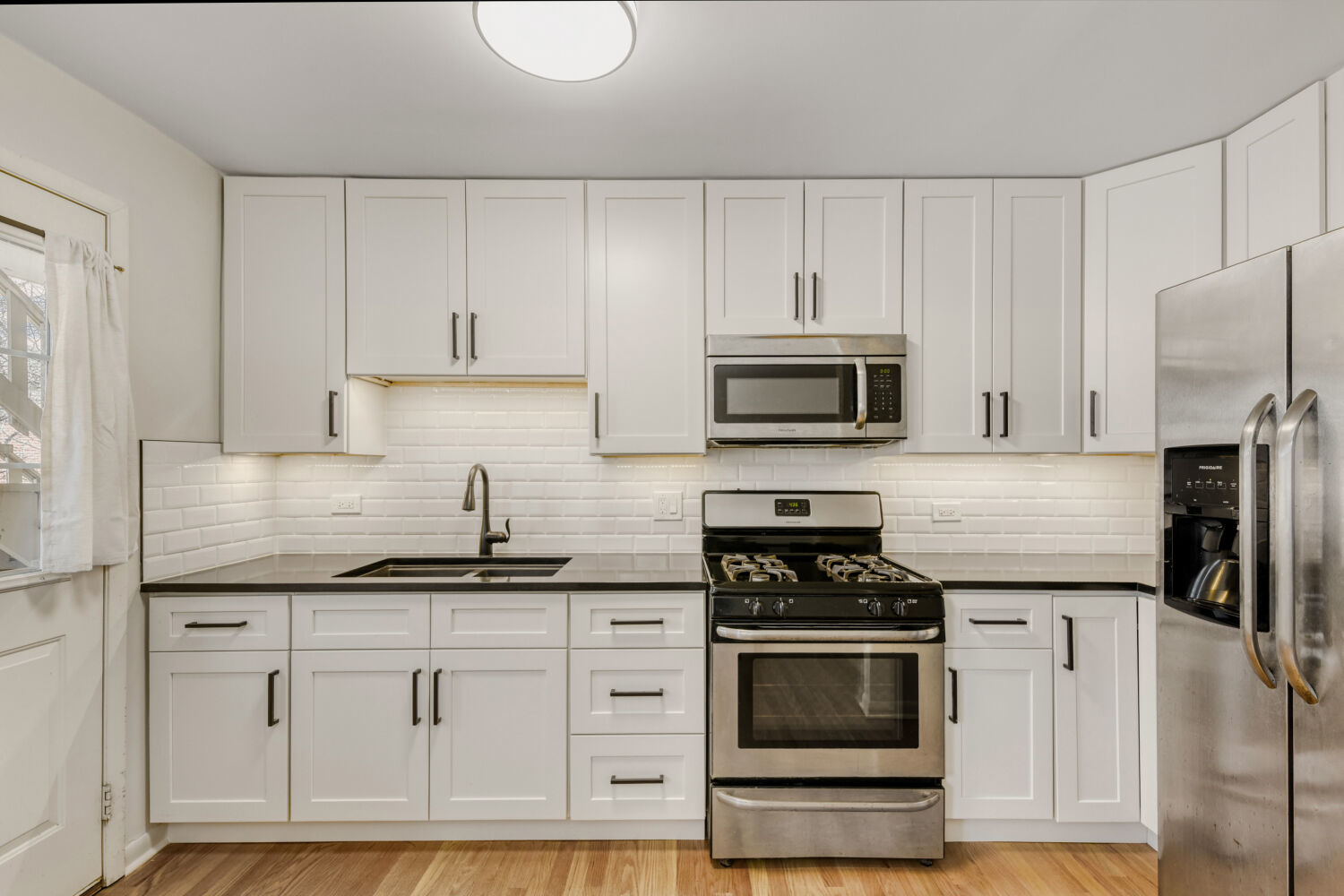 1710 Dempster Street, Unit B Park Ridge, IL 60068 - Photo 17 of 27 a kitchen with granite countertop white cabinets and stainless steel appliances