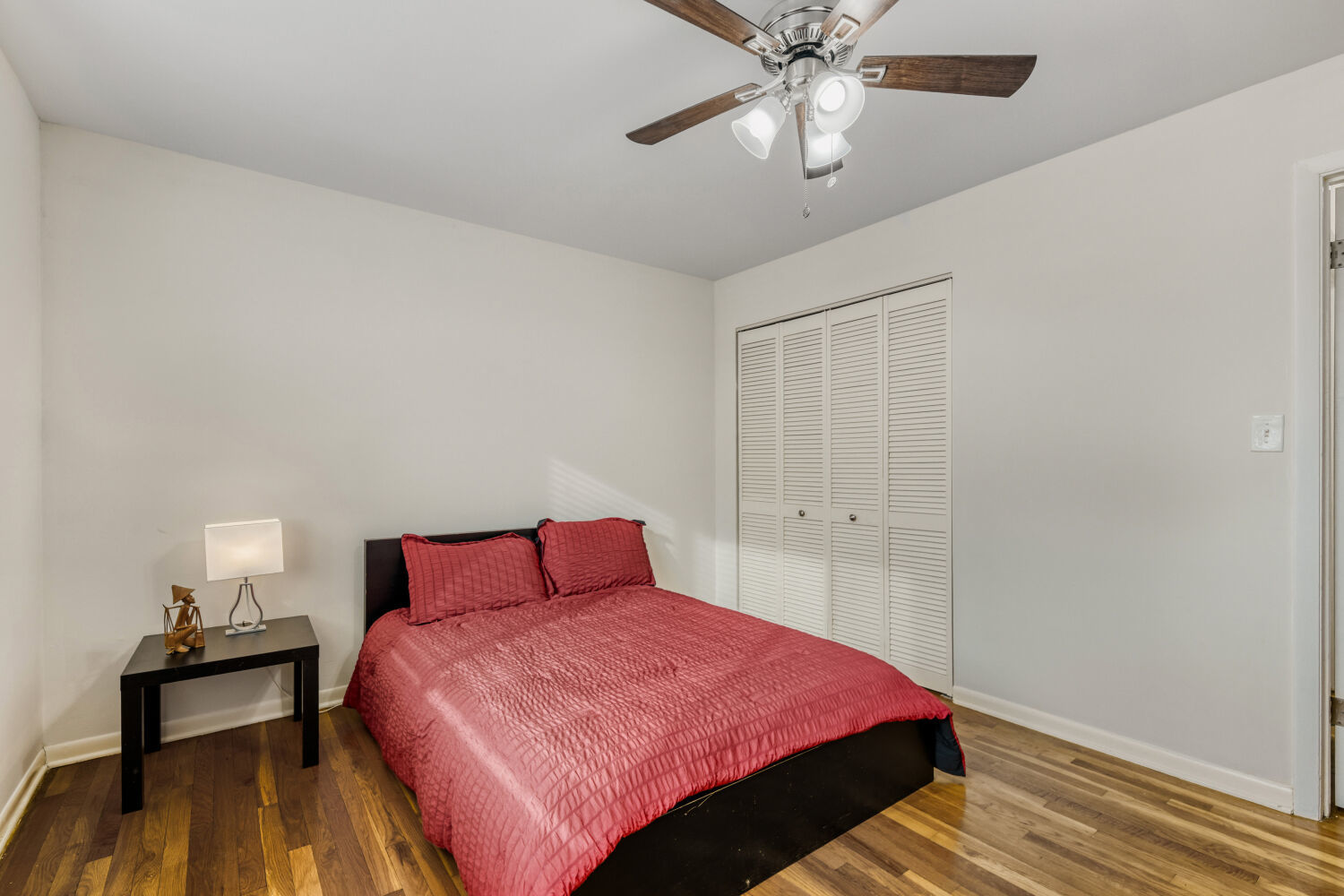 1710 Dempster Street, Unit B Park Ridge, IL 60068 - Photo 22 of 27 a bedroom with a bed and a chandelier