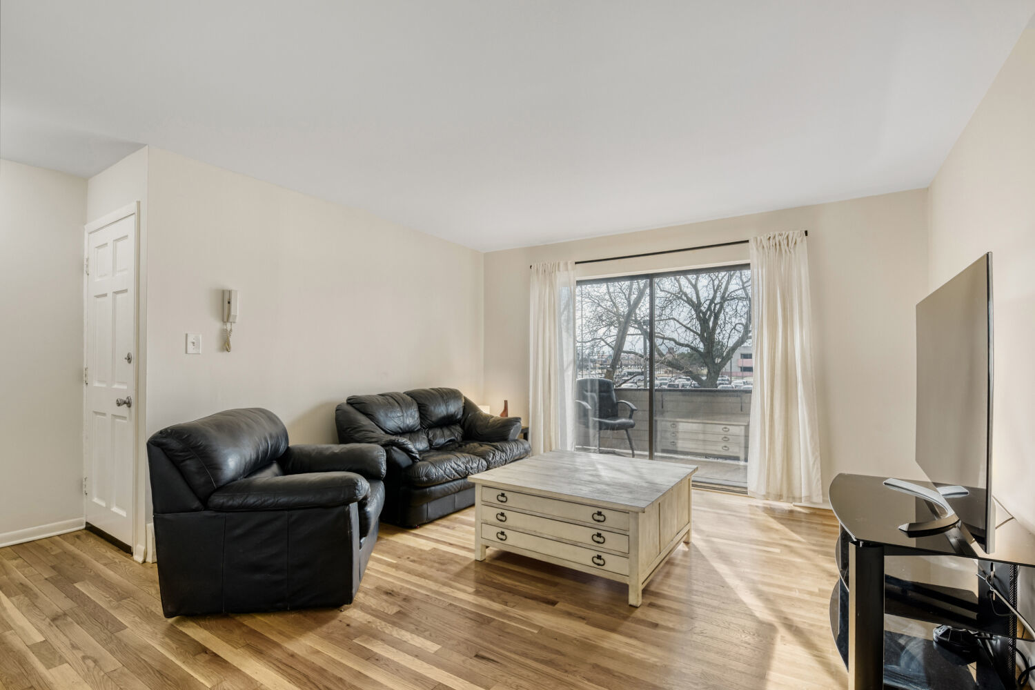 1710 Dempster Street, Unit B Park Ridge, IL 60068 - Photo 5 of 27 a living room with furniture and a flat screen tv