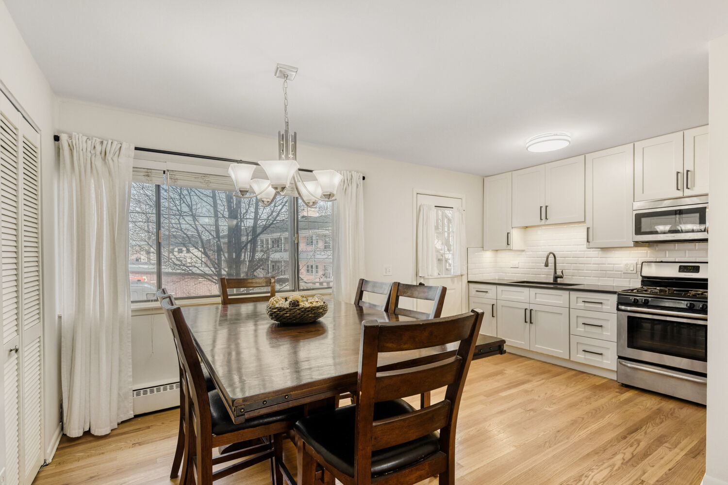 1710 Dempster Street, Unit B Park Ridge, IL 60068 - Photo 9 of 27 a dining room with furniture a chandelier and wooden floor