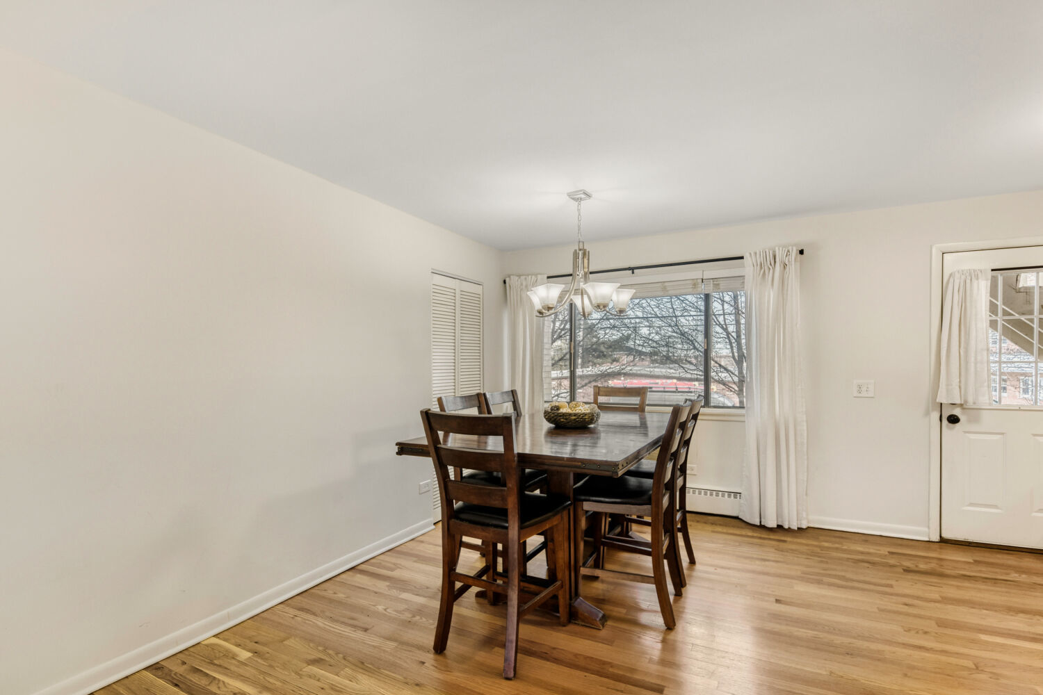 1710 Dempster Street, Unit B Park Ridge, IL 60068 - Photo 10 of 27 a view of a dining room with furniture and wooden floor