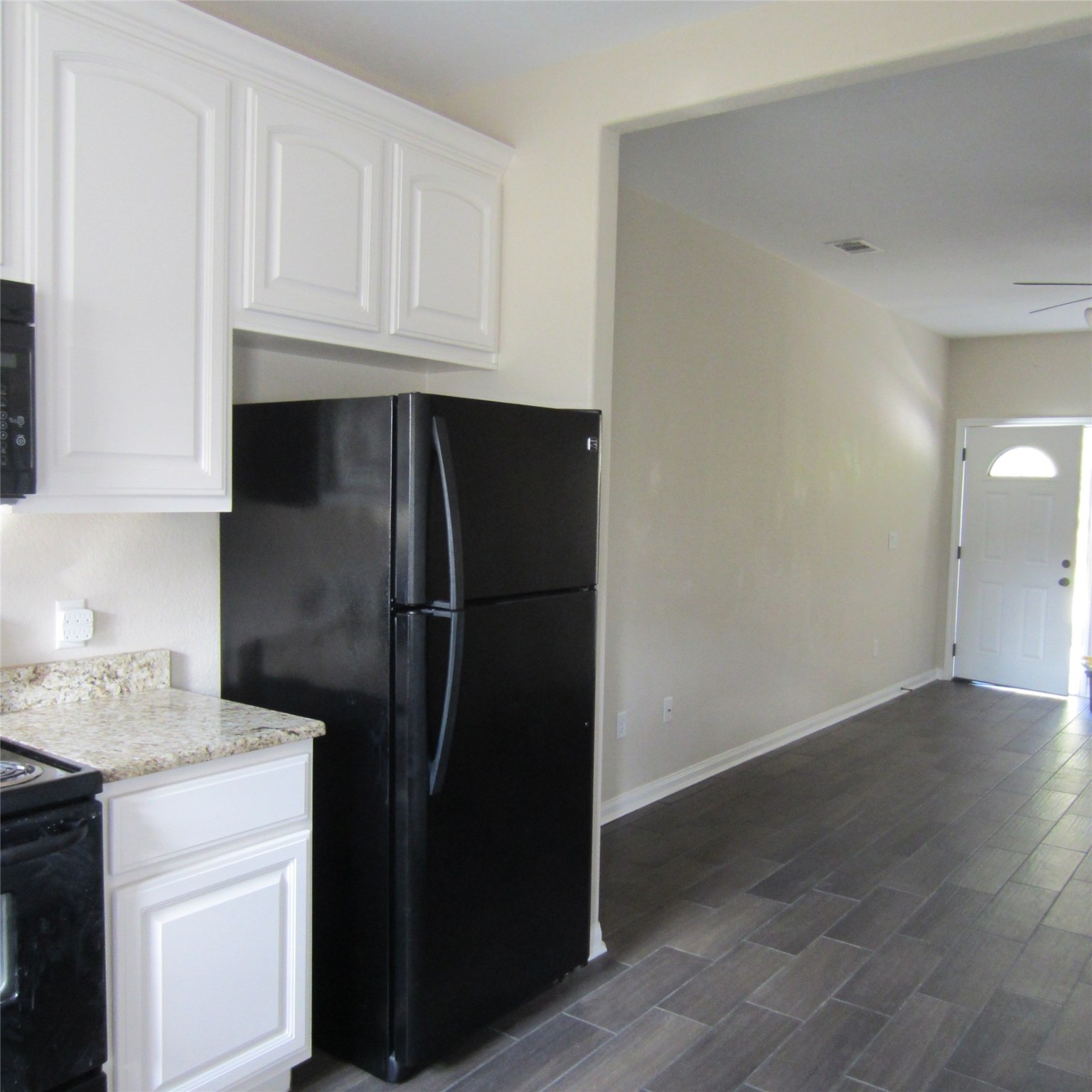 23431 Mcspadon Road, Unit 23415 Porter, TX 77365 - Photo 4 of 10 a kitchen with a refrigerator and cabinets