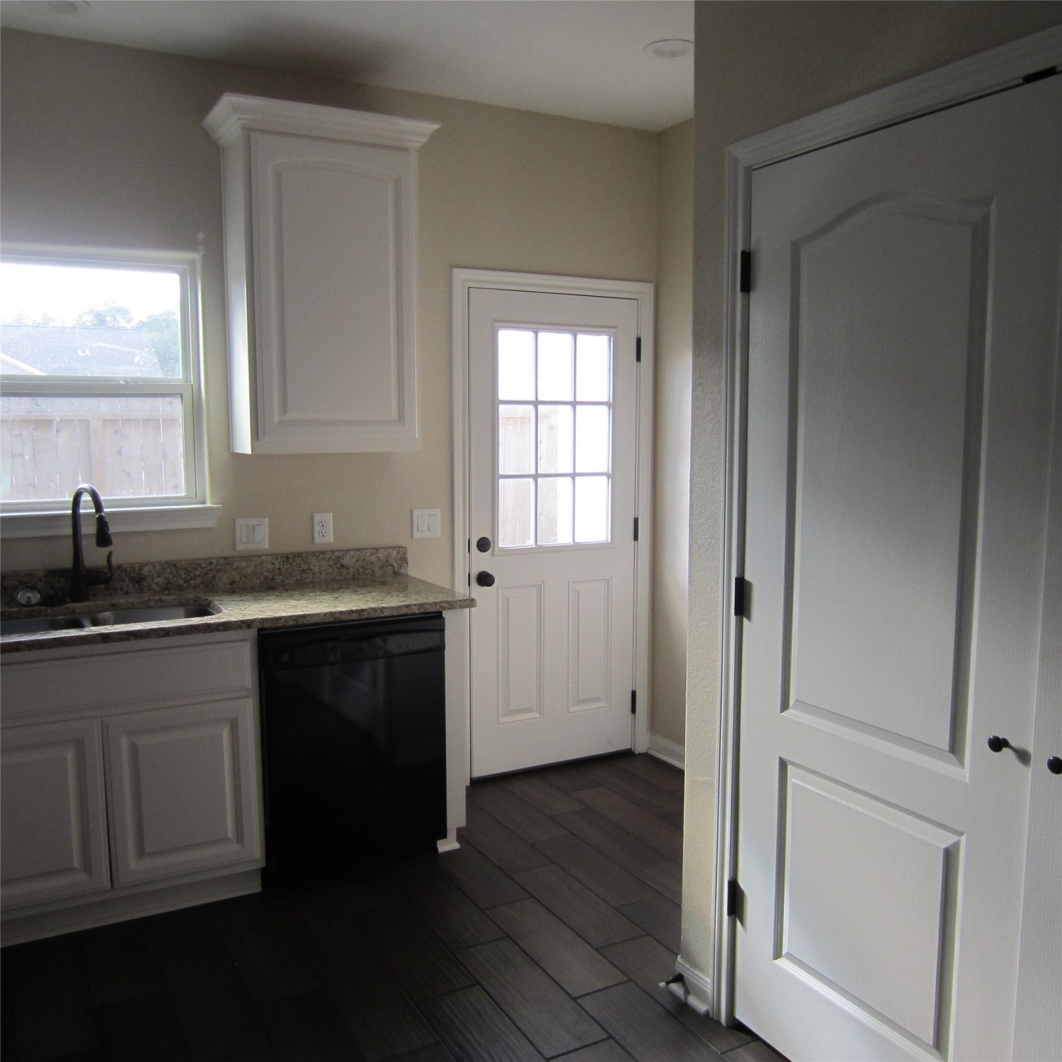 23431 Mcspadon Road, Unit 23415 Porter, TX 77365 - Photo 10 of 10 a kitchen with granite countertop white cabinets and sink
