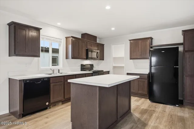 a kitchen with a sink stove and refrigerator