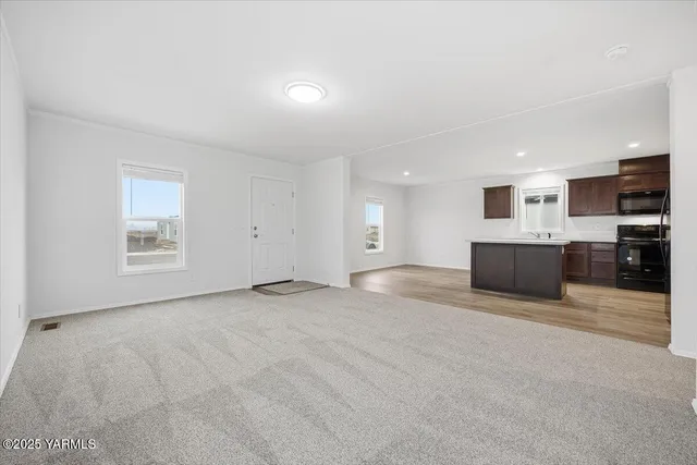 a view of a kitchen with a sink and a stove top oven