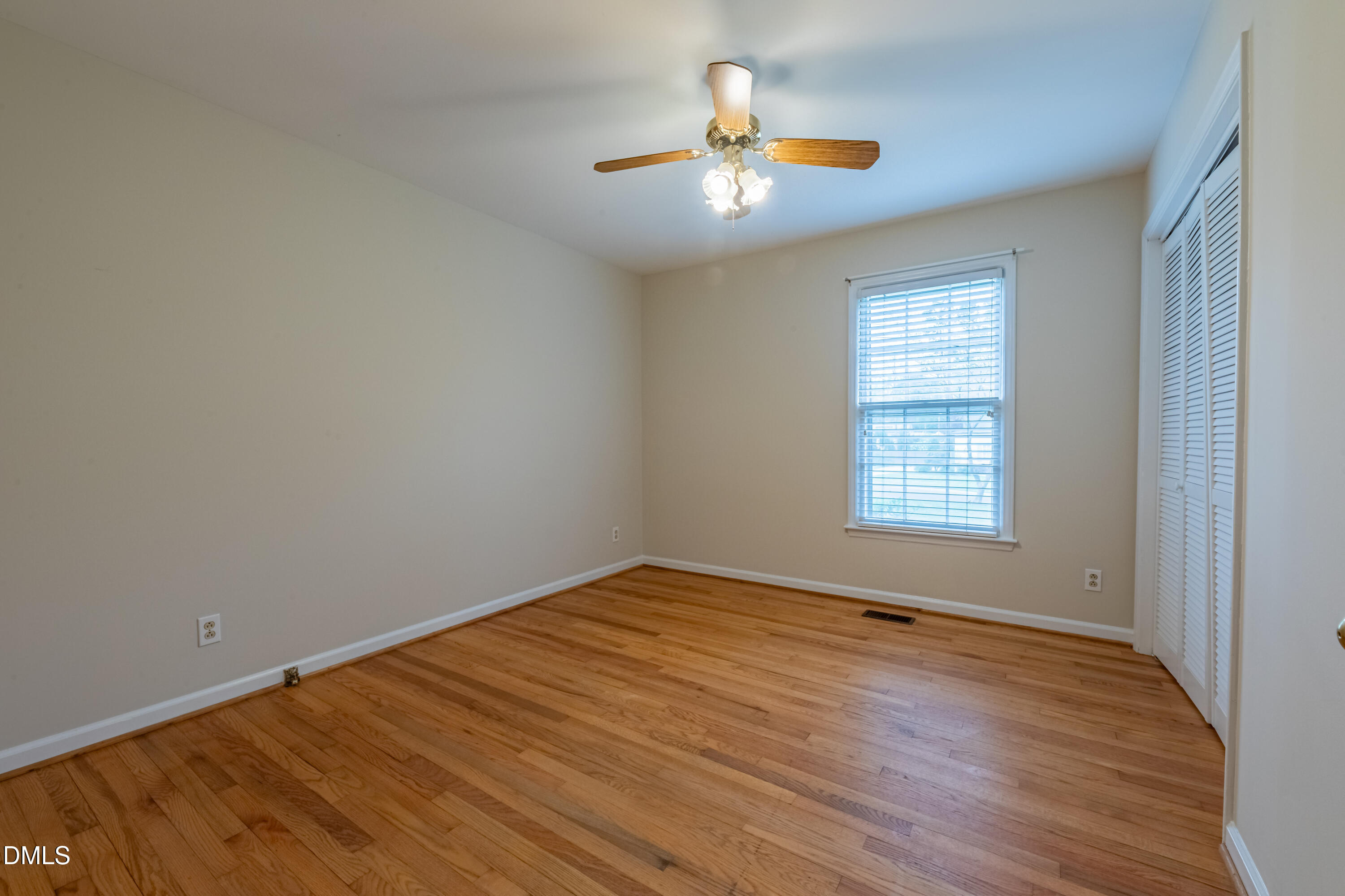408 Ortega Road Raleigh, NC 27609 - Photo 14 of 25 wooden floor in an empty room with a window