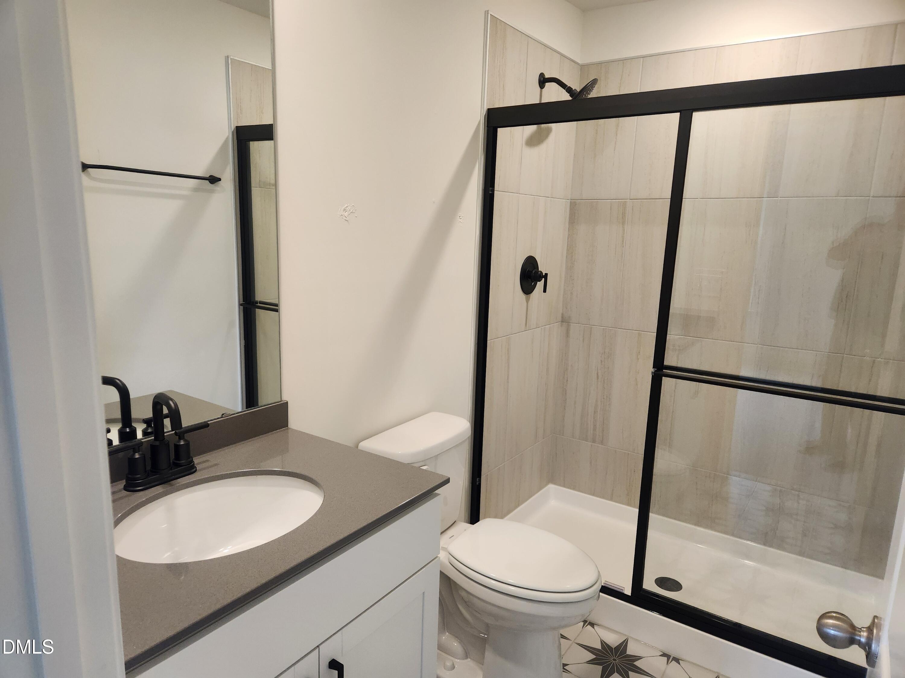 2218 Rabbitbrush Street Durham, NC 27704 - Photo 4 of 12 a bathroom with a granite countertop sink toilet and shower