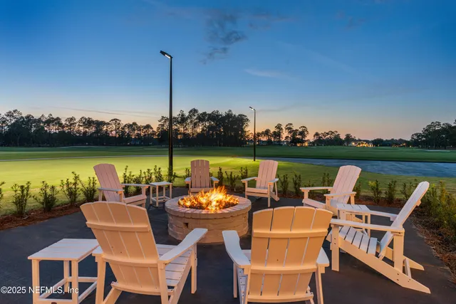 an aerial view of a residential houses with outdoor space and parking