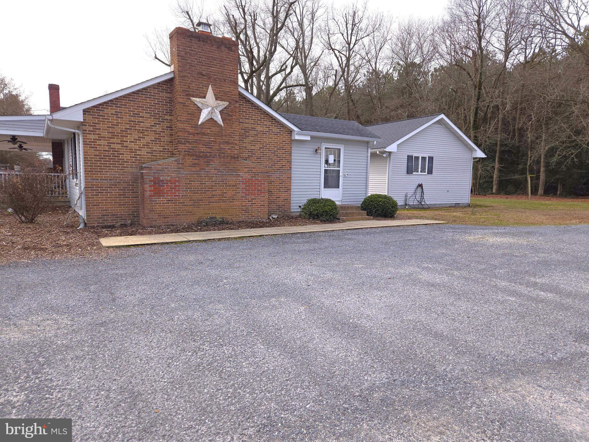 21498 Dover Bridge Road Preston, MD 21655 - Photo 3 of 33 a front view of a house with a yard and garage
