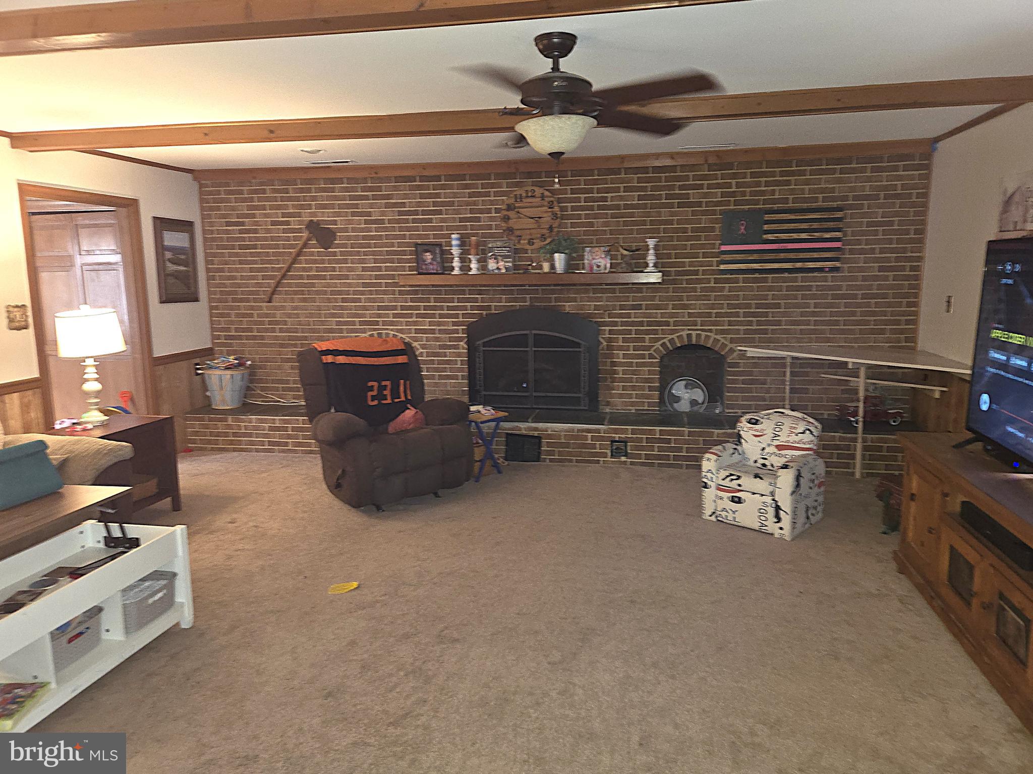 21498 Dover Bridge Road Preston, MD 21655 - Photo 7 of 33 a living room with furniture and a fireplace