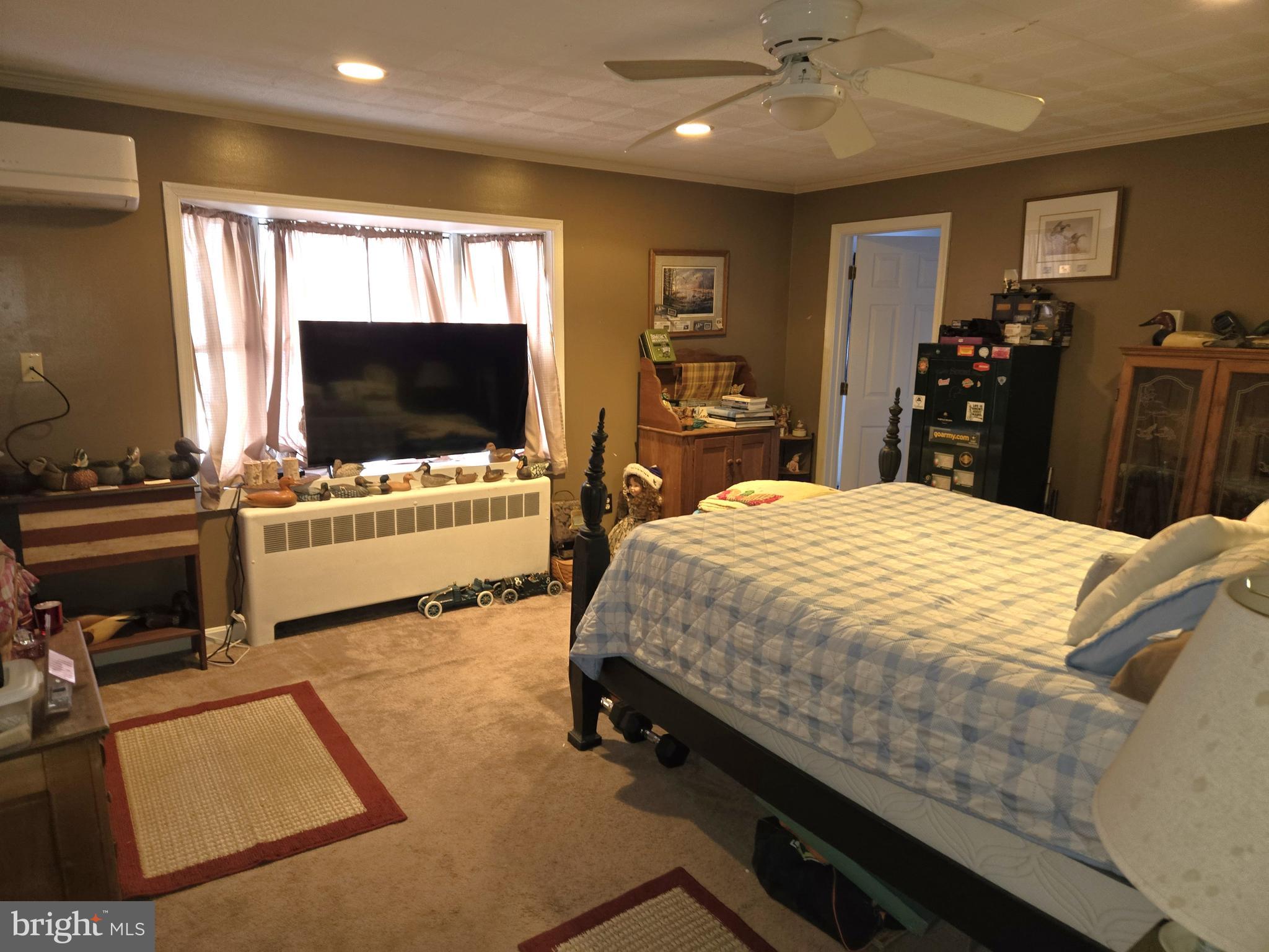 21498 Dover Bridge Road Preston, MD 21655 - Photo 10 of 33 a bedroom with a bed and a flat screen tv