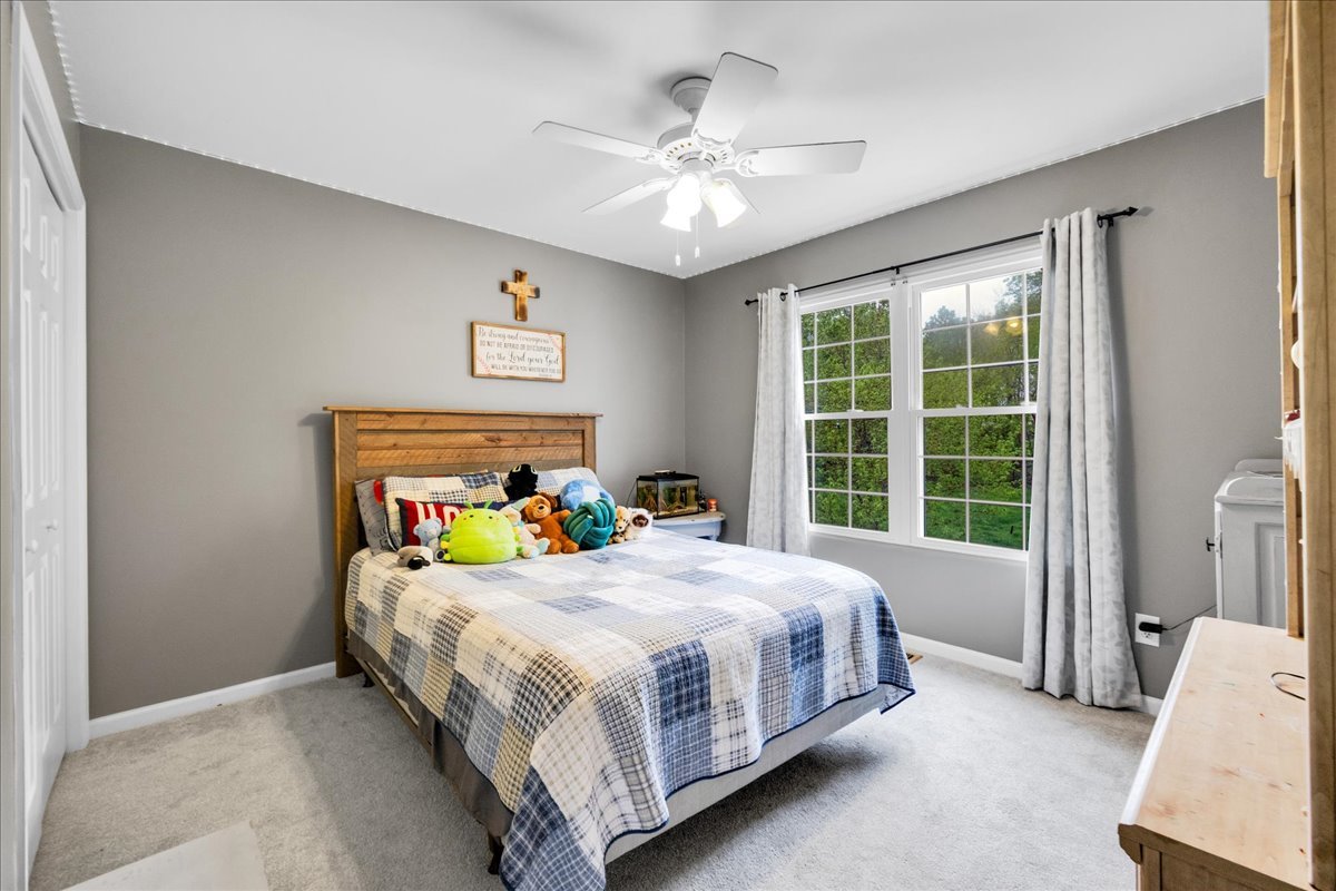 911 Fawn Ridge Court, Unit B Yorkville, IL 60560 - Photo 19 of 37 a bedroom with a bed and a large window