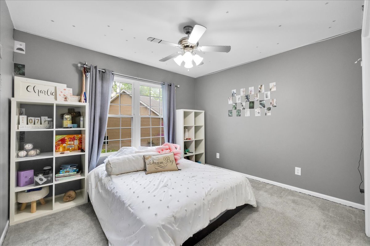 911 Fawn Ridge Court, Unit B Yorkville, IL 60560 - Photo 22 of 37 a bedroom with a large bed and a chandelier