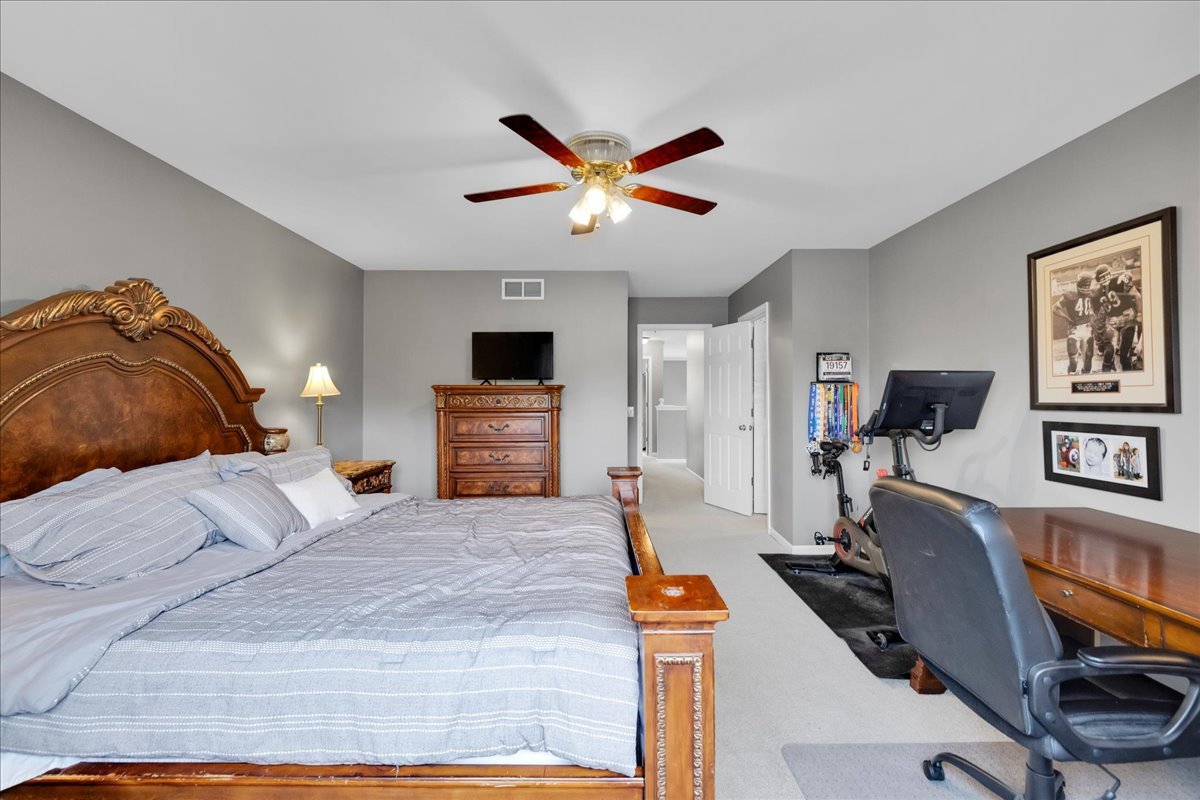 911 Fawn Ridge Court, Unit B Yorkville, IL 60560 - Photo 27 of 37 a bedroom with a bed and wooden floor