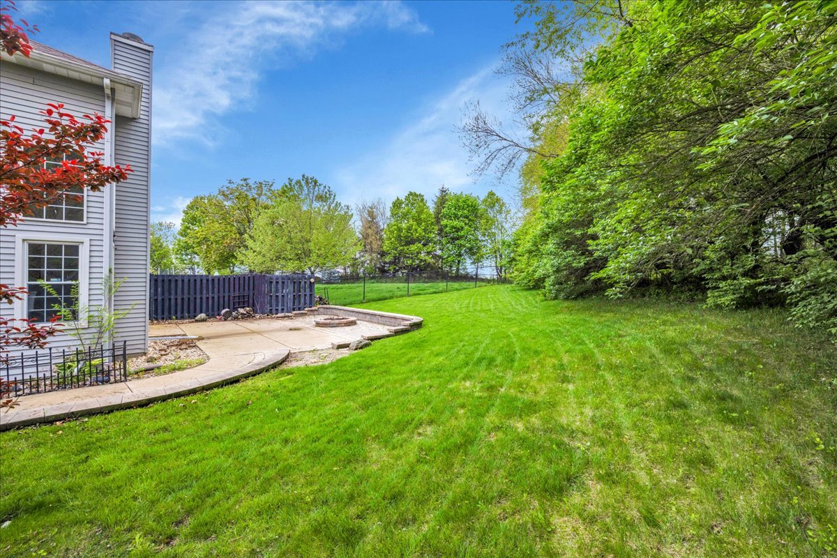 911 Fawn Ridge Court, Unit B Yorkville, IL 60560 - Photo 31 of 37 a view of a back yard with a patio