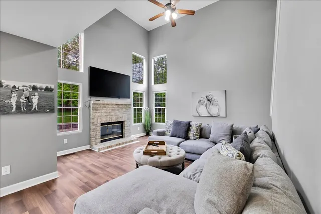 a living room with furniture a fireplace and a flat screen tv