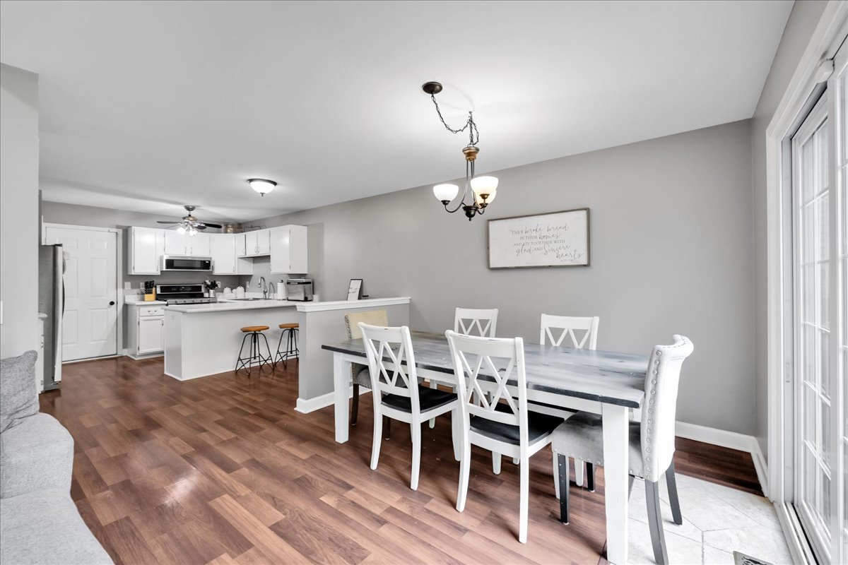 911 Fawn Ridge Court, Unit B Yorkville, IL 60560 - Photo 9 of 37 a view of a dining room with furniture and wooden floor
