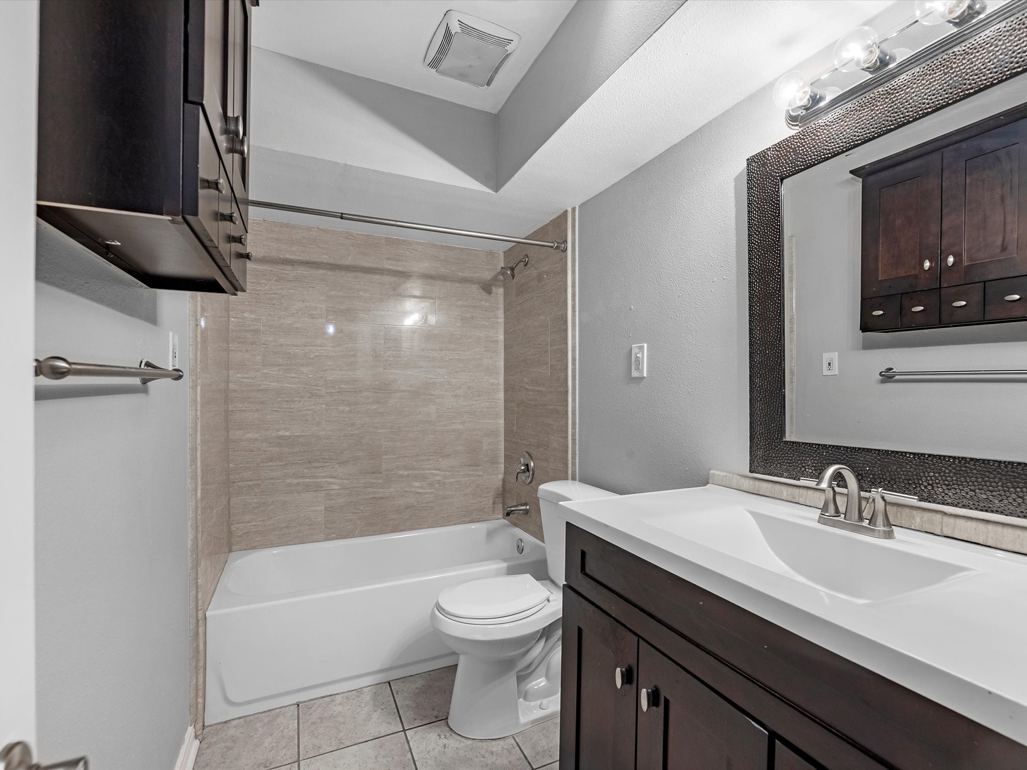 2647 Marilee Lane Houston, TX 77057 - Photo 21 of 26 a bathroom with a bathtub shower sink vanity mirror and toilet