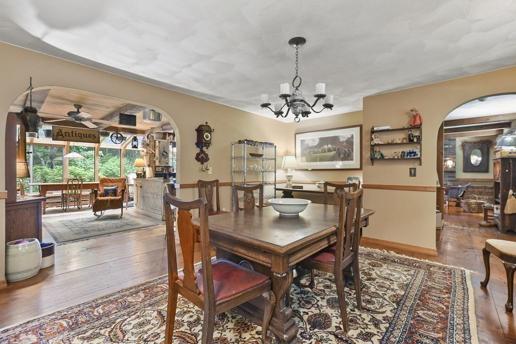 259 Hollis Road Lunenburg, MA 01462 - Photo 15 of 39 a living room with dining table and a wooden floor