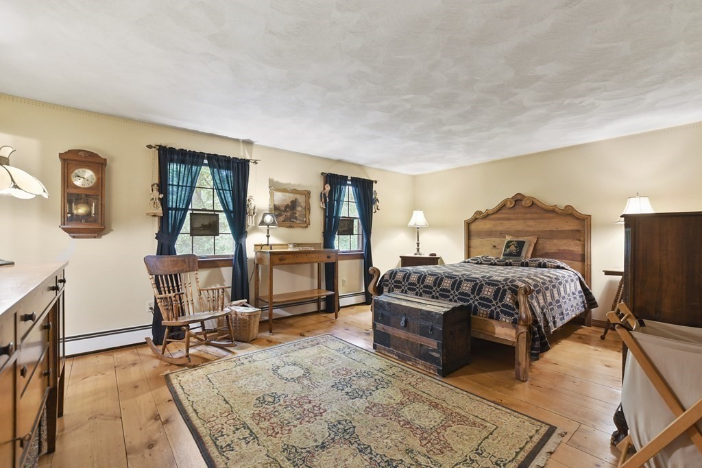 259 Hollis Road Lunenburg, MA 01462 - Photo 21 of 39 a bedroom with a bed a table and chair