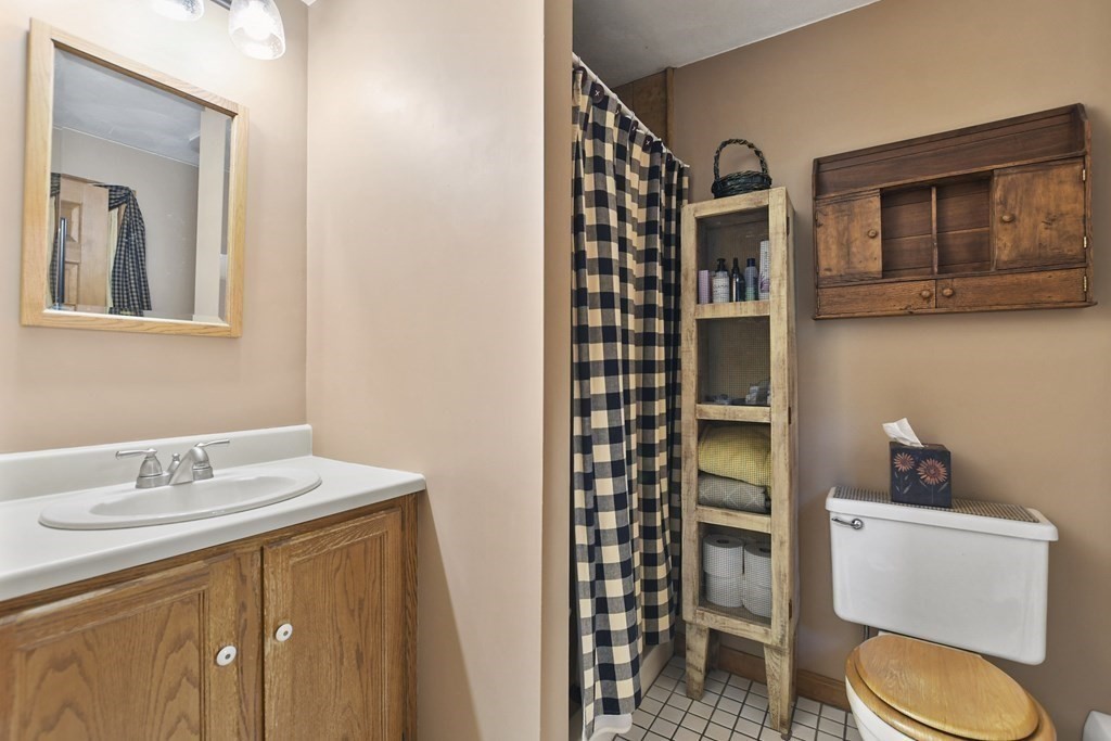 259 Hollis Road Lunenburg, MA 01462 - Photo 23 of 39 a bathroom with a toilet a sink and a mirror
