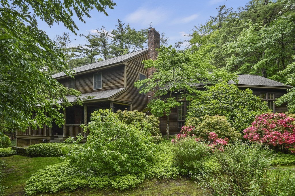 259 Hollis Road Lunenburg, MA 01462 - Photo 37 of 39 a house is sitting in the middle of garden