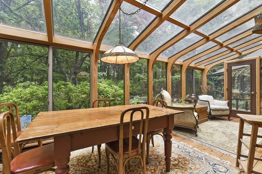 259 Hollis Road Lunenburg, MA 01462 - Photo 5 of 39 a view of a dining room with furniture large windows and wooden floor